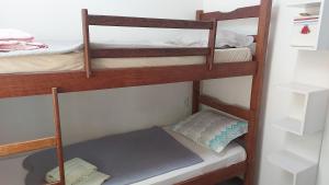 a room with three bunk beds in a room at Recanto Águas Claras in Soledade de Minas