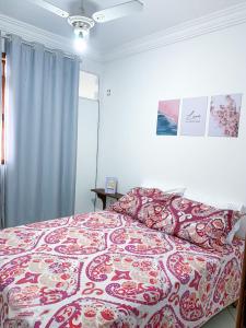 a bedroom with a bed with a red and white blanket at Spazio Martinelli in Santa Teresa
