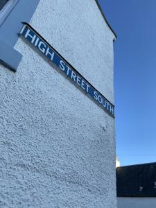a street sign on the side of a building at The Crail Maltings in Crail +19 photos