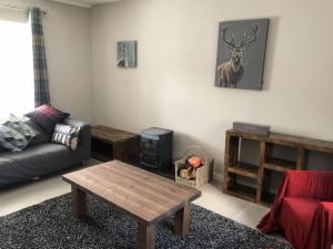 a living room with a couch and a coffee table at Garron House in Auchterarder