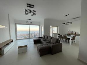 a living room with a couch and a dining room at Casa Langellotti plus in Naples