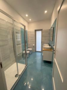 a bathroom with a shower and a sink and a toilet at Casa Langellotti plus in Naples +51 photos