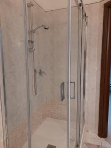 a shower with a glass door in a bathroom at Il Girasole in Caserta +6 photos