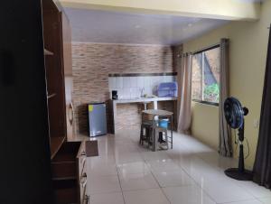 a kitchen with a counter and a table in a room at House la Rose Second Floor in Manuel Antonio