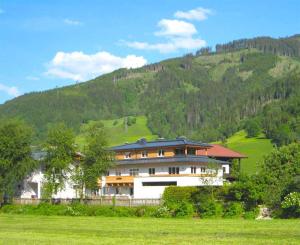 a large house in front of a mountain at Apartment Riccardo - by Alpen Apartments in Kaprun