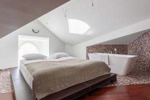 a bedroom with a bed and a bath tub at Old Town - Demini Apartment in Tallinn