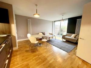 a kitchen and living room with a table and chairs at City Apartment with Terrace in Leicester