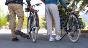 two people standing with their bikes on the street at Canmore Rocky Mountain Inn in Canmore