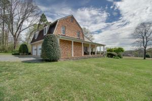 a brick house with a large yard in front of it at Pet-Friendly Cottage with Game Room and Fire Pit! in Syria