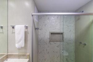 a bathroom with a shower with a glass door at Garvey 106 in Brasilia +24 photos