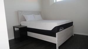 a bed in a room with a white mattress at Afan Home of Joy in Winnipeg