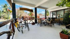 two bikes parked on a porch with tables and chairs at Hotel MAYARI Holbox in Holbox Island