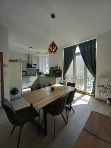 cocina y comedor con mesa de madera y sillas en R&N Sea Breeze, en Blankenberge