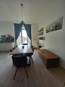 a living room with a wooden table and chairs at R&N Sea Breeze in Blankenberge
