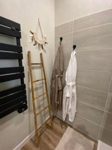 a room with three racks of clothes on a wall at Entre Honfleur et Etretat in Octeville-sur-Mer