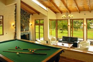a pool table in a living room with a fireplace at Hacienda Tres Lagos in Aldana