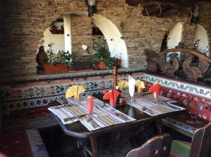 a dining room with a table with umbrellas on it at Gurko Hotel in Veliko Tŭrnovo