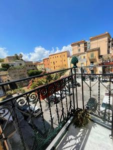 a balcony with a black railing and some buildings at La Baronessa in Palermo