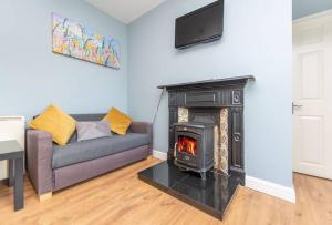 a living room with a couch and a fireplace at Clonbur House - One bedroom apartment in Galway