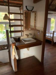 a bathroom with a sink and a mirror at Casa, Cabo Tortugas, Monterrico in Monterrico