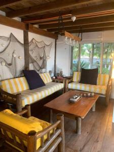 a living room with two couches and a table at Casa, Cabo Tortugas, Monterrico in Monterrico