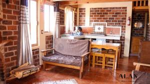 a living room with a chair and a table at Hotel y Cabañas Alan in Chignahuapan