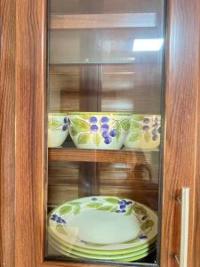 a glass cabinet with plates and bowls in it at LA CASA DE MAMA LUZ in San Felipe de Puerto Plata