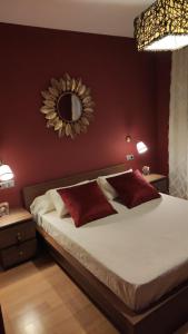 1 dormitorio con 1 cama con espejo en la pared en El Rincón de Arles, en Jerez de la Frontera