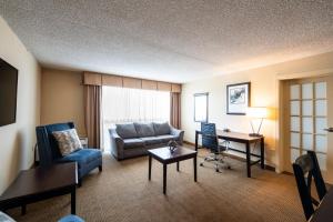 a living room with a couch and a desk in a hotel room at Holiday Inn South Plainfield-Piscataway, an IHG Hotel in South Plainfield