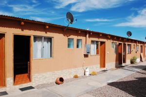 a building with satellite dishes on top of it at Hostal Pablito in San Pedro de Atacama