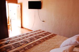 Ένα ή περισσότερα κρεβάτια σε δωμάτιο στο Hostal Pablito
