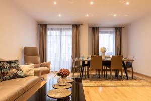 a living room with a couch and a table at Basha Apartment PREMIUM Sopot 2 in Sopot