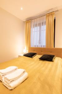 a bedroom with two pillows on a bed with a window at Basha Apartment PREMIUM Sopot 2 in Sopot