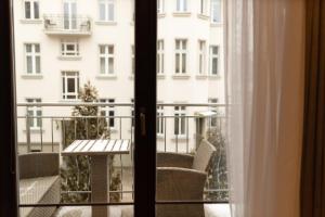 a balcony with a table and a view of a building at Basha Apartment PREMIUM Sopot 2 in Sopot