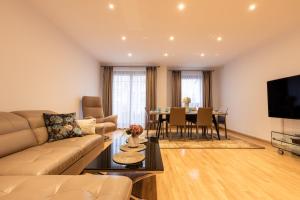 a living room with a couch and a table at Basha Apartment PREMIUM Sopot 2 in Sopot