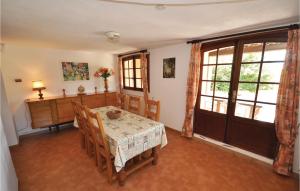 a dining room with a table and chairs and a window at Domaine De La Bastide Dagay in Agay - Saint Raphael