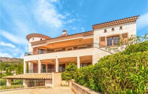 a large building with a balcony on top of it at Domaine De La Bastide Dagay in Agay - Saint Raphael