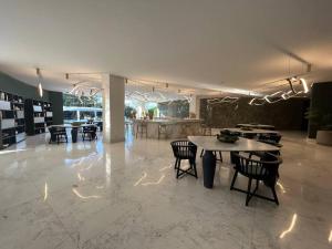 a room with a table and chairs and a kitchen at Departamento Brisa del Mar Punta Mita, Beach Front in Bucerías