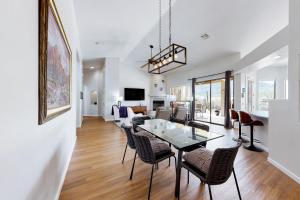 a dining room and living room with a table and chairs at Starmist Mountain View in Oro Valley