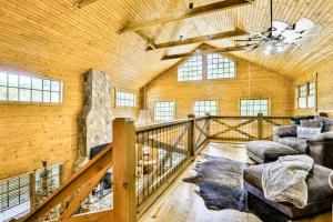 a large room with a wooden ceiling and a staircase at Ivylog Creek Getaway in Young Harris