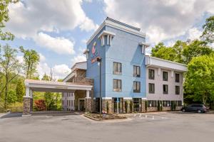 a large blue building with a parking lot at Comfort Suites At Kennesaw State University in Kennesaw