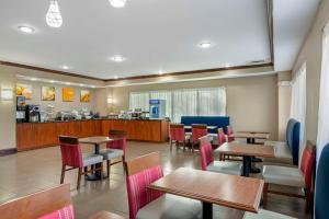 um restaurante com mesas e cadeiras e um balcão em Comfort Suites At Kennesaw State University em Kennesaw