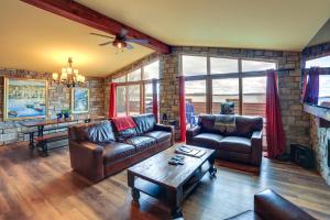 a living room with two leather couches and a table at Prairie-Style Home on Garden Bay with Deck and Hot Tub in Garden