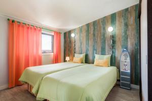 a bedroom with a large bed and a window at HC Torreira Beach in Torreira