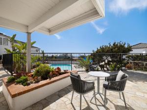 a patio with a table and chairs and a pool at Hotel Indigo San Diego Del Mar, an IHG Hotel in San Diego