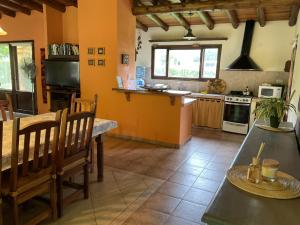 a kitchen with a table and chairs in a room at Chalet Ailinco in Valle Grande