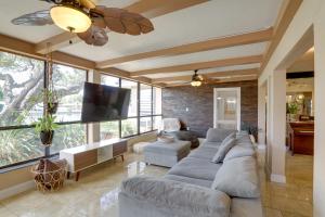a living room with a large couch and a tv at Waterfront Home with Game Room, 2 Miles to Beach! in Seminole