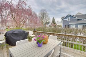 a white table with flowers on a wooden deck at Spacious South Haven Retreat Near Lake Michigan in South Haven