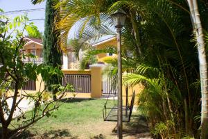 a street light in front of a house with palm trees at The Vista Inn in Falmouth