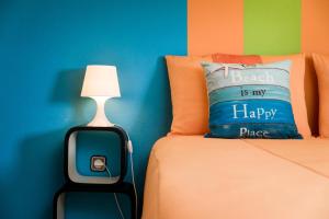 a bedroom with a bed with a pillow and a lamp at HC Torreira Beach in Torreira